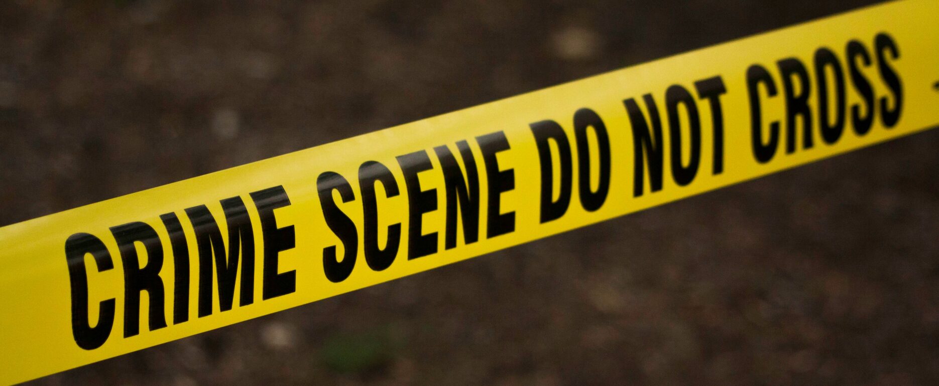 Yellow Crime Scene Tape across a potential crime scene.