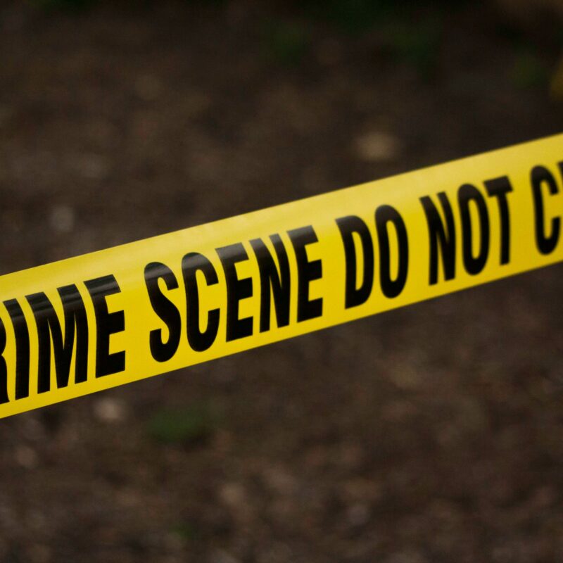 Yellow Crime Scene Tape across a potential crime scene.