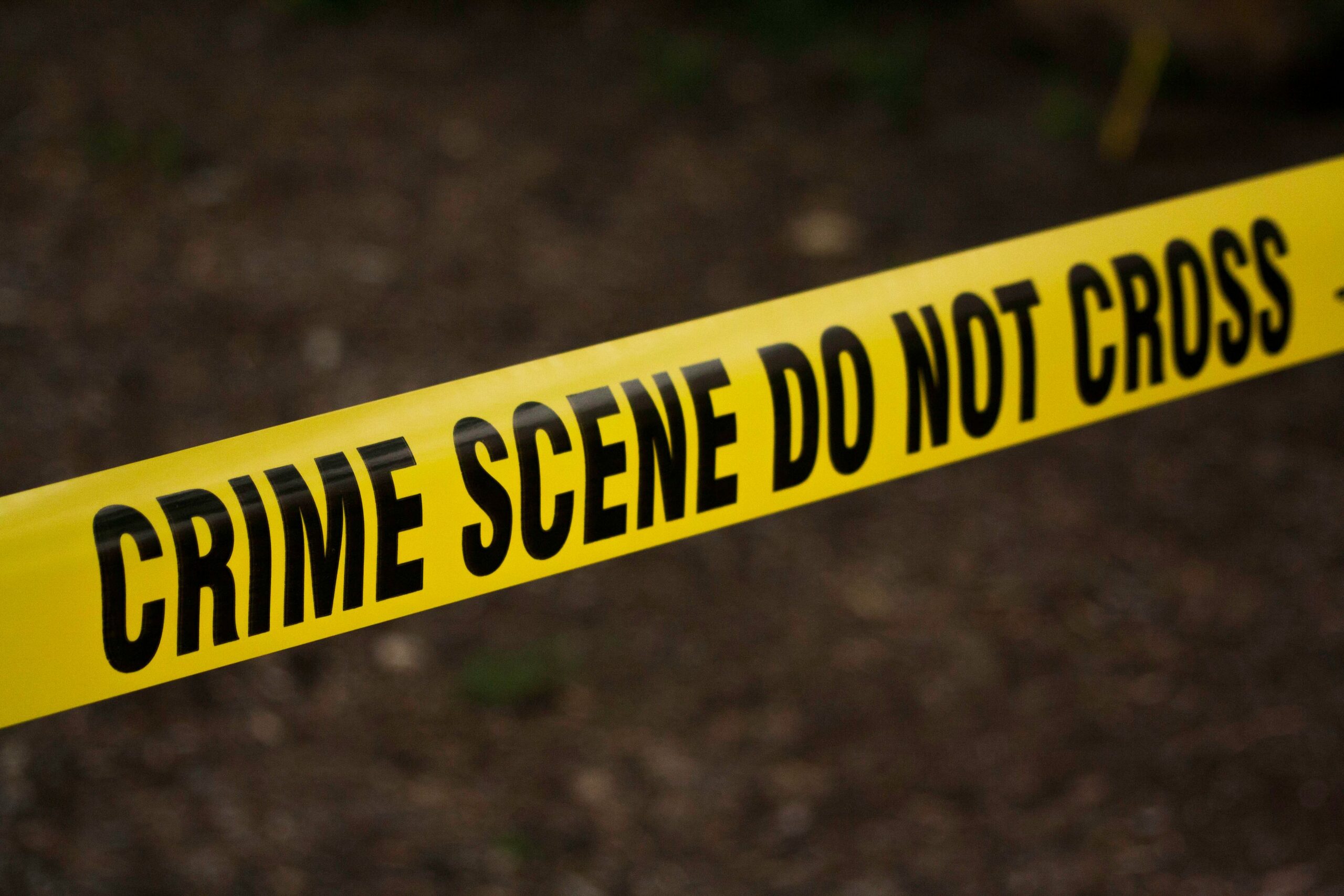 Yellow Crime Scene Tape across a potential crime scene.