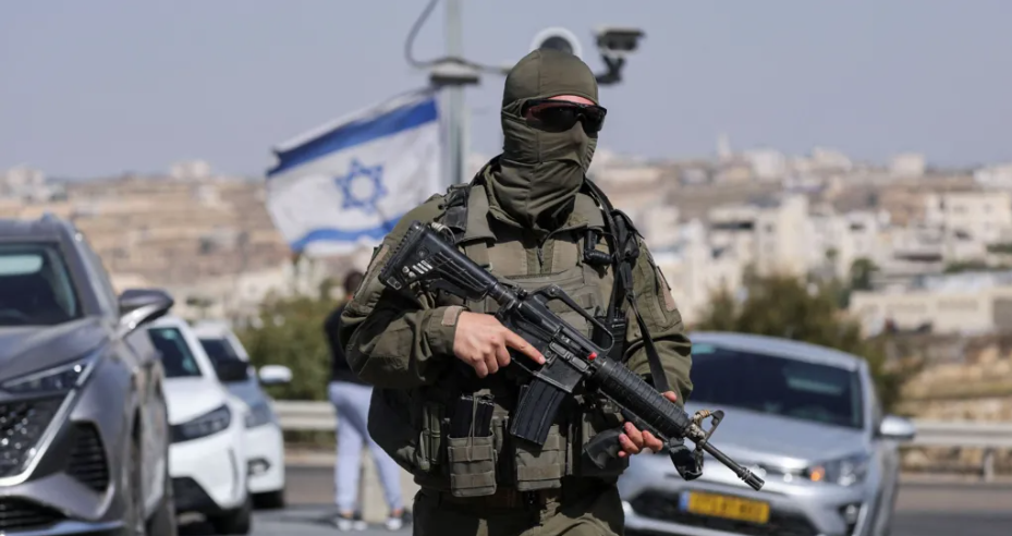 A member of the Israeli forces is seen in Hebron in the occupied West Bank following Friday’s shooting [Ammar Awad/Reuters]